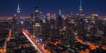 Vibrant U.S. metropolitan cityscape illuminated at night, showcasing diverse evening entertainment.