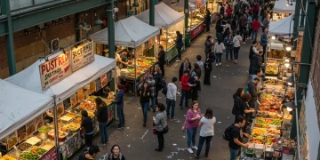 Overhead view of a vibrant U.S. city food market with diverse authentic local cuisine stalls
