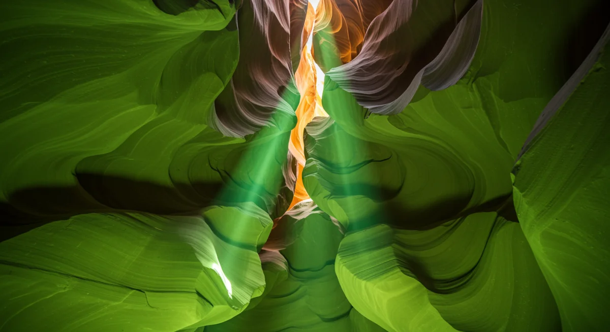 Sunlight illuminating the smooth, sculpted walls of a vibrant green slot canyon.